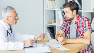 A doctor reviewing medical documents with a male patient, highlighting the importance of medical records in personal injury cases.
