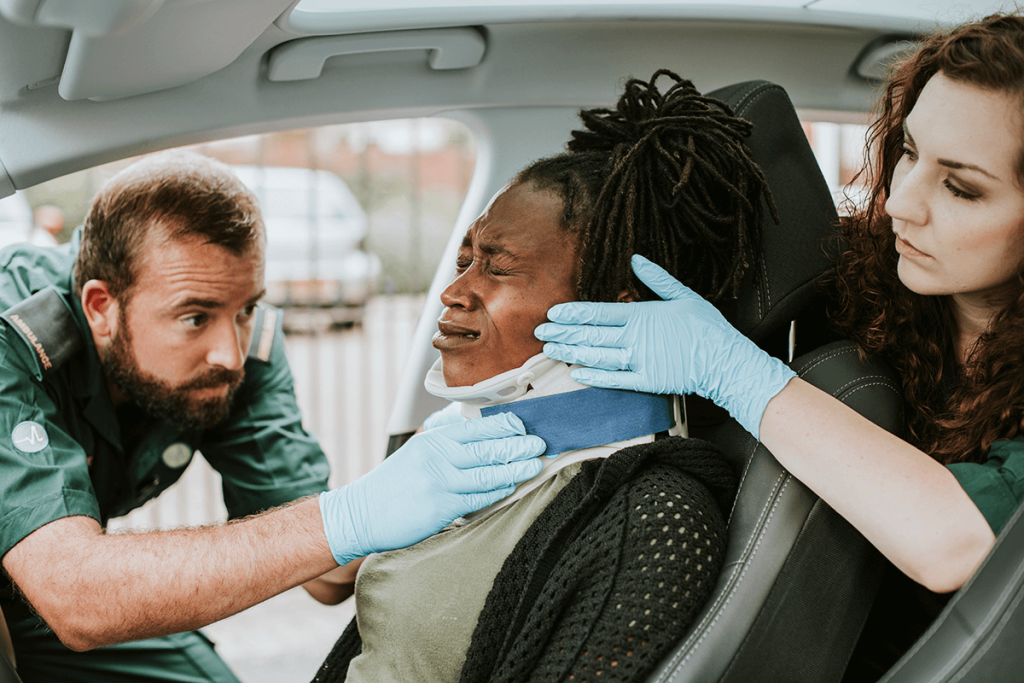 Emergency responders assisting a woman with neck injury in a vehicle, highlighting the impact of accidents on personal safety in Sherman Oaks.